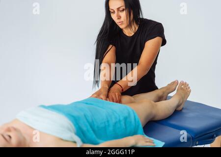 Anti-cellulite massage of hips. lymph drainage treatment. Woman receiving professional body, leg and foot massage. Wellness, healing and relaxation Stock Photo