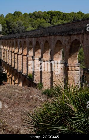 A view to the arches of the ancient Roman Aqueduct in Tarragona. Stock Photo