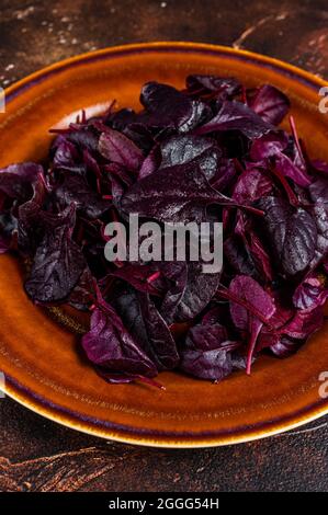 Raw Ruby or red chard salad Leafs on a rustic plate. Dark background. Top view Stock Photo