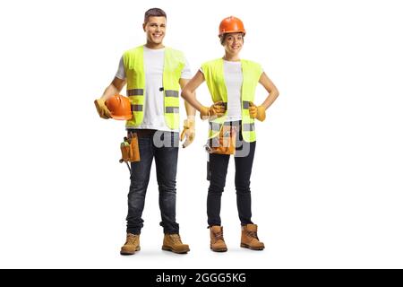 Full length portrait of a male and female construction workers wearing hardhats isolated on white background Stock Photo