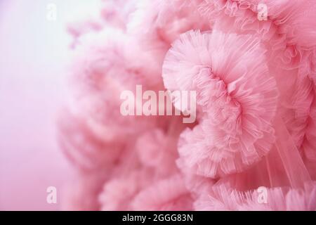 Texture Pink background from the airy fabric of the dress. Copy space for text about design and fashion. Stock Photo
