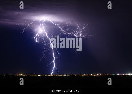 A vivid lightning bolt strike in a monsoon thunderstorm over Phoenix, Arizona Stock Photo