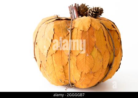 Decorative pumpkin made of yellow leafs isolated against white background. Thanksgiving concept Stock Photo
