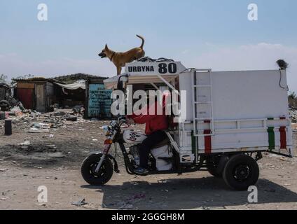 Non Exclusive: People during the collection and separation of waste that arrives daily at the largest garbage dump in Mexico Bordo de Xochiaca, which Stock Photo