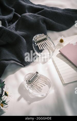 Glass Kalimba mini 8 keys. Kalimba or mbira is an African musical instrument. Traditional Kalimba made from glass board with metal, play on hands and Stock Photo