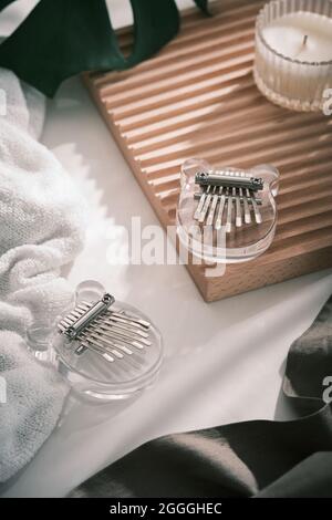 Glass Kalimba mini 8 keys. Kalimba or mbira is an African musical instrument. Traditional Kalimba made from glass board with metal, play on hands and Stock Photo
