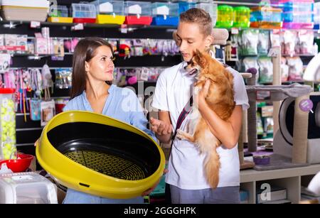 Young woman and boy choosing plastic toilet Stock Photo