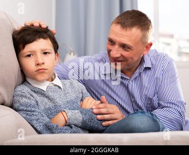 Father consoling sad son Stock Photo