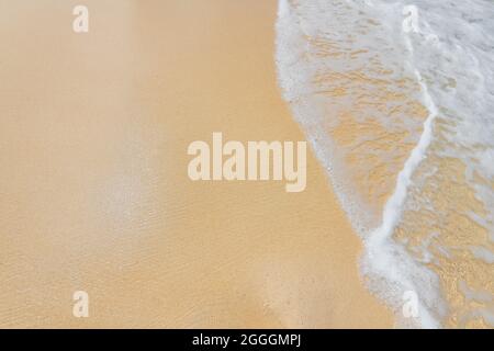 Soft ocean wave on clean sandy beach Stock Photo