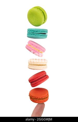 Colorful macaroons levitating on a finger. Levitation food photography concept. Stock Photo