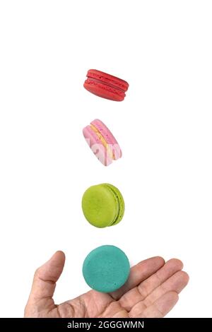 Colorful macaroons levitating on a hand. Levitation food photography concept. Stock Photo