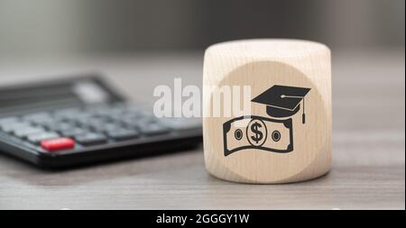 Wooden block with symbol of fafsa concept and calculator on background Stock Photo