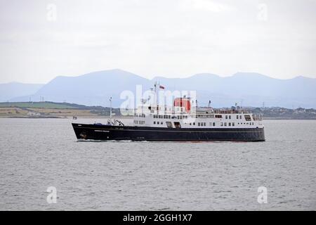 HEBRIDEAN PRINCESS leaving Holyhead harbour, with the Snowdon mountain range beyond, North Wales Stock Photo