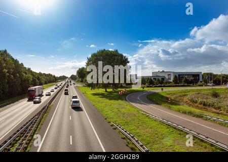 Cars and trucks driving on the A44 highway near the South-Holland village of Sassenheim in the township Teylingen in the Netherlands. At the Exit Hote Stock Photo