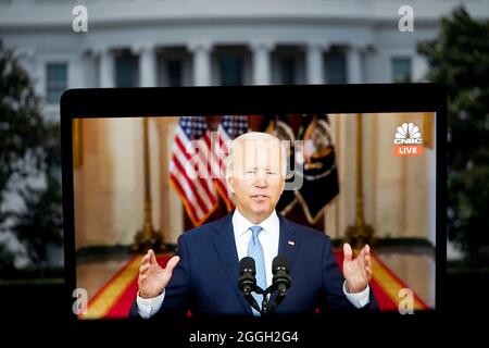 Washington, DC, USA. 31st Aug, 2021. U.S. President Joe Biden is seen on screen as he delivers remarks at the White House in Washington, DC Aug. 31, 2021. Joe Biden on Tuesday defended his decision to hastily pull U.S. troops out of Afghanistan, a mission broadly criticized by the American public. Credit: Liu Jie/Xinhua/Alamy Live News Stock Photo