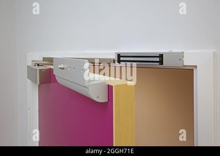 Electromagnetic door lock system on a new health centre door in London, UK. Part of an electronic access control system. Stock Photo