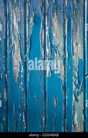 weathered blue door with peeling paint Stock Photo
