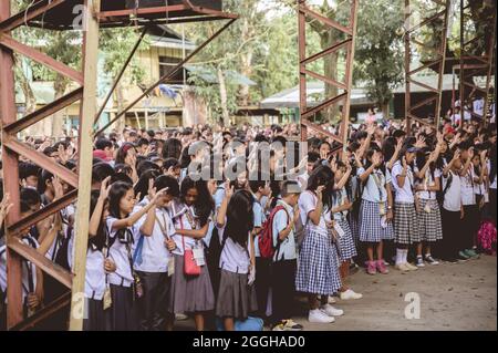 BACOLOD, PHILIPPINES - Mar 01, 2019: A group of Filipino high school students gathering for a corporate speech Stock Photo