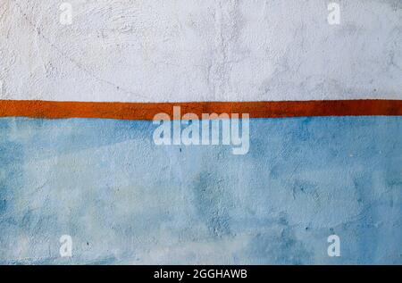 Blue and white wall whit orange fringe, abstract background or texture Stock Photo