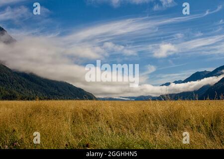 Low hanging clouds over grassland Stock Photo