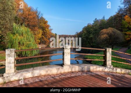 Autumn landscape from river bridge. Colorful leaves in autumn park Stock Photo