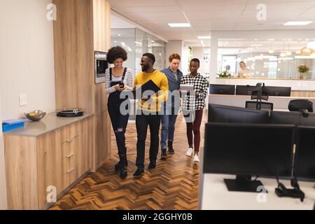 Diverse male and female colleagues working together Stock Photo