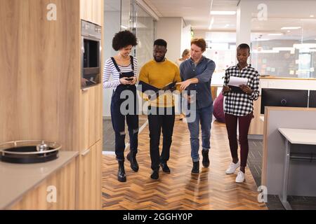 Diverse male and female colleagues working together Stock Photo