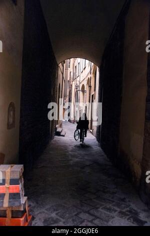 Barrel vaulted medieval cobblestone street in Florence, Italy. Stock Photo