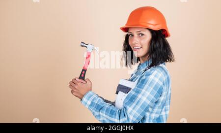 Creating perfection. professional manual worker. technician working using hammer tool. safety uniform. equipment for repairing. mechanic girl in Stock Photo