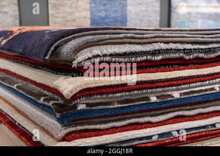 Pile of Multi Colored Carpets Rugs At Market stack. Stock Photo