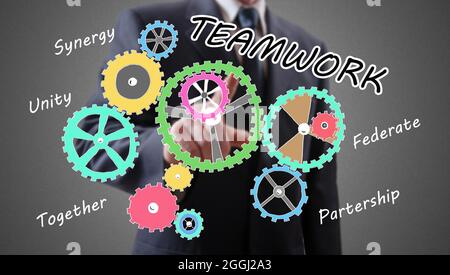Teamwork concept shown by a businessman in background Stock Photo
