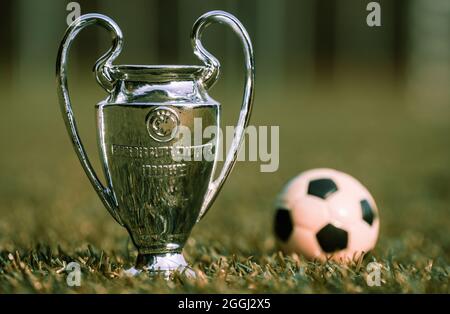 August 27, 2021 St. Petersburg, Russia. The UEFA Champions League Cup on the green turf of the stadium. Stock Photo