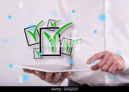 Validation concept above a tablet held by a man in background Stock Photo
