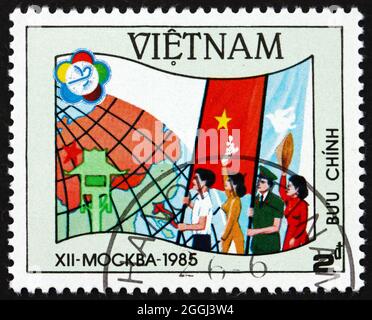 VIETNAM - CIRCA 1985: a stamp printed in Vietnam shows Youth Carrying Flags and Globe, 12th World Youth and Students Festival, Moscow, circa 1985 Stock Photo