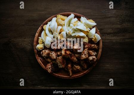 Grilled chicken and eggs on a plate for salad bar Stock Photo