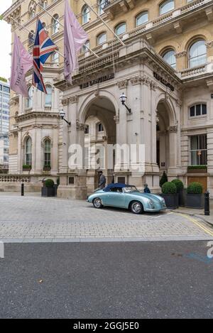 Light blue convertible Porsche Speedster (possibly a 356?) sports car, parked on the forecourt of The Langham Hotel. Stock Photo