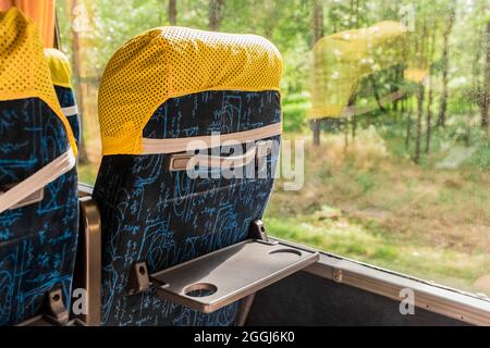Back of seat with handle for hands in public transport bus. Stock Photo