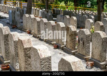 Rows of stone tombstones in a public cemetery Stock Photo