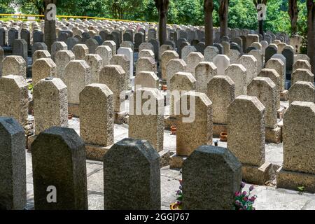 Rows of stone tombstones in a public cemetery Stock Photo