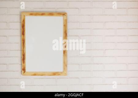 Black frame mockup on table against white wall, Stock Photo