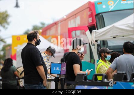 New York, USA. 31st Aug, 2021. People wait outside a mobile vaccine clinic in New York, the United States, on Aug. 31, 2021. Credit: Wang Ying/Xinhua/Alamy Live News Stock Photo
