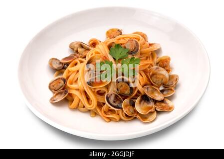 Linguine pasta in a tomatoes clams sauce with parsley served on a white plate isolated on white Stock Photo