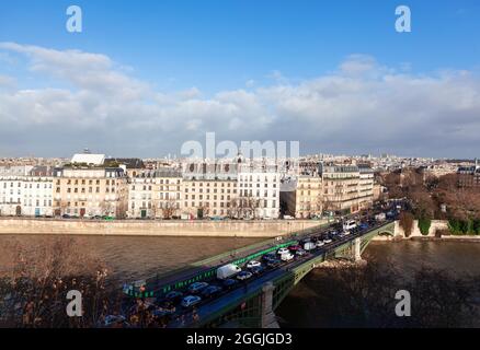 Morning Traffic jam in Paris . Cars in a traffic  jam on the Sully Bridge . Residential district at Ile Saint-Louis at Seine riverside in Paris Stock Photo