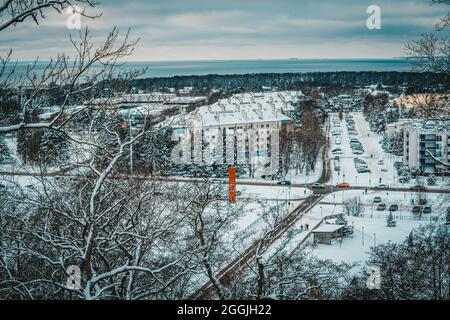 A  view from cliffed coast (abrasion coast) on Haabneeme settlement with a parking lot between the parks during a cold winter evening. Stock Photo