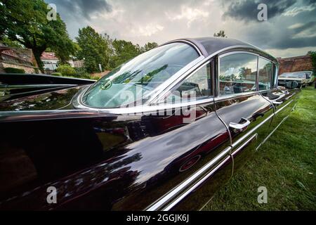 Cadillac Fleetwood, rear view of the classic American road cruiser from 1959 with large tail fins in Lehnin, Germany, August 21, 2021,illustrative edi Stock Photo