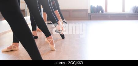 low section of The graceful legs of ballet dancers standing in a row on their toes Stock Photo