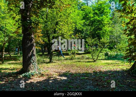 Maintenance of public park and gardens. Municipal workers cleaning public park Cismigiu Gardens in Bucharest, Romania, 2021 Stock Photo