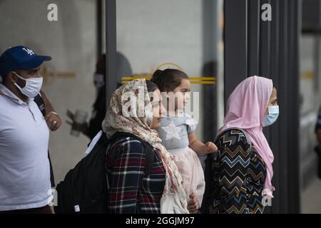 Chantilly, VA, USA. 1st Sep 2021.Refugees evacuated from Afghanistan arrive at Washington Dulles International Airport and make their way to a waiting bus in Chantilly, VA, USA, 26 miles west of Downtown Washington DC, on Wednesday, September 1, 2021. Photo by Rod Lamkey / CNP/ABACAPRESS.COM Credit: Abaca Press/Alamy Live News Stock Photo