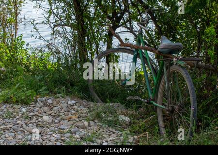 Abandoned bicycle near a lake. Stock Photo
