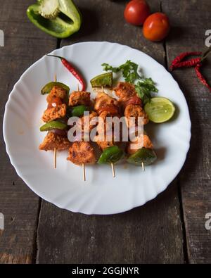 Chicken kebabs or doners grilled with saute vegetables in a white plate. Close up. Stock Photo